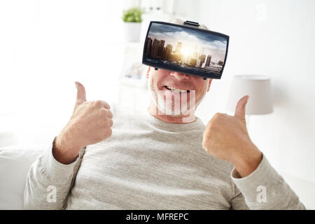 old man in virtual reality headset shows thumbs up Stock Photo