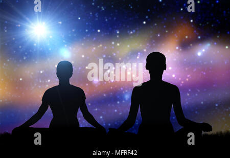 black silhouette of couple meditating over space Stock Photo