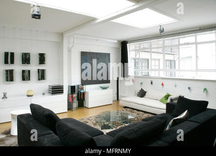 Seating around coffee table in modern sitting room Stock Photo