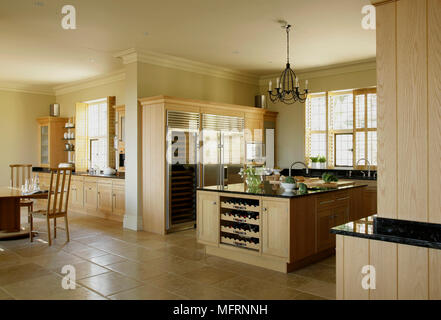 Modern country style kitchen with central island unit and wood units Stock Photo