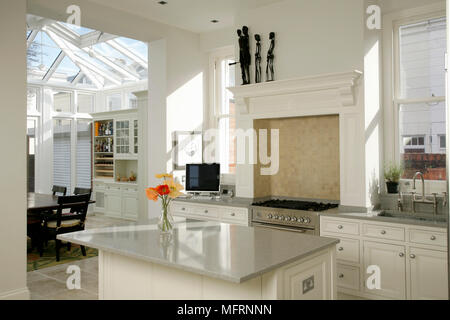 Modern kitchen with central island unit and white units Stock Photo