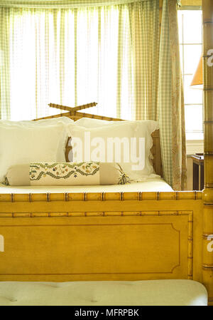 Wooden four poster with bed canopy in traditional style bedroom Stock Photo