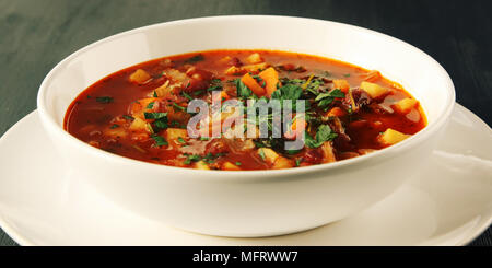 Tomato soup with red beans, potato and carrot. Vegan diet. European cuisine. Vegetarian dish. Main course. Organic meal. Side view. Wide photo. Stock Photo