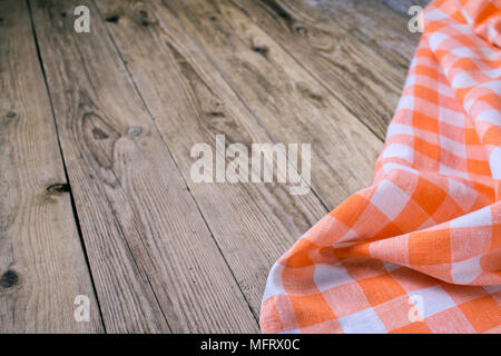 Checkered napkin on the wooden background. Top view. Stock Photo