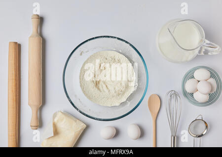 top view of glass bowl with flour on table Stock Photo