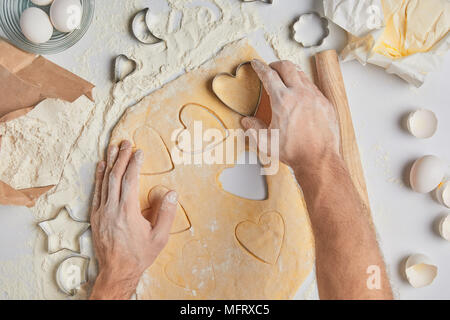 cropped image of chef preparing heart shaped cookies, valentines day concept Stock Photo