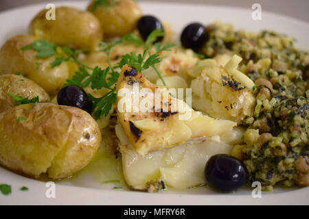 Typical Portuguese dish - Bacalhau com batata assada e migas de feijão frade (cod fish with olive oil, potatoes and 'frade' bean 'migas') Stock Photo