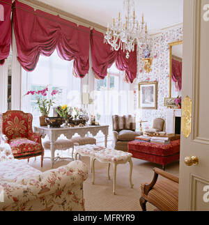 Sitting room with red draped curtains and chendelier Stock Photo