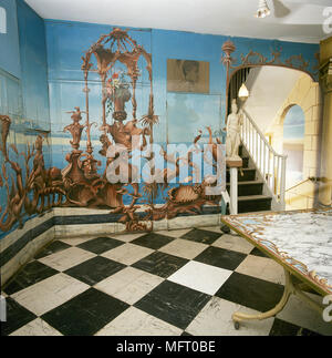 Dramatic hallway, ornate painted mural, black white tiled floor, marble top table, Stock Photo
