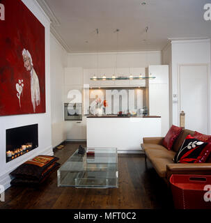 Brown leather sofa in front of transparent coffee table and fireplace in contemporary open plan room Stock Photo