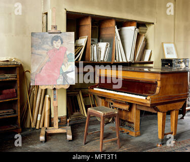 Artists studio with an old fashioned traditional feel art materials easel piano interiors rooms studios workrooms spaces period distressed worn musica Stock Photo
