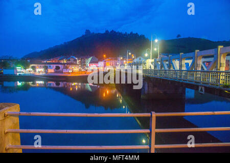 River Deva and view of the village from Bustio at night. Unquera, Cantabria, Spain. Stock Photo
