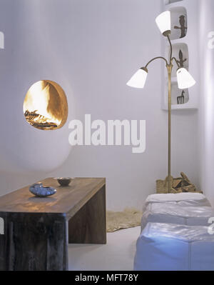 A detail of a modern white sitting room with leather cube cushions and retro floor lamp Stock Photo