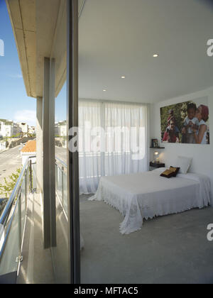 View of double bed in bedroom from outside sliding door Stock Photo
