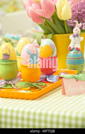 Decorated eggs in cups for Easter lunch Stock Photo