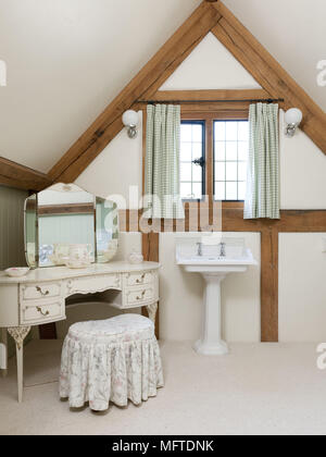 Dressing table in corner of country style bedroom with washbasin Stock Photo