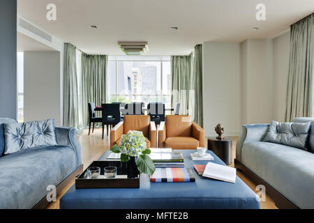 Upholstered seating around coffee table in modern sitting room Stock Photo