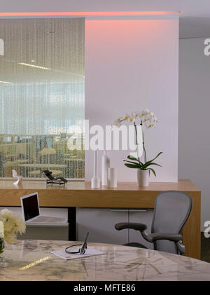 Chair at oval desk in modern office Stock Photo