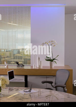 Chair at oval desk in modern office Stock Photo