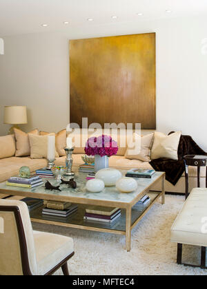 Upholstered seating around coffee table in modern sitting room Stock Photo