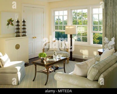 Upholstered seating around coffee table in traditional sitting room Stock Photo