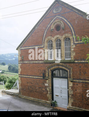 The exterior of a converted Victorian chapel arched windows Stock Photo