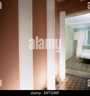 Three lit floor lamps in hallway Stock Photo