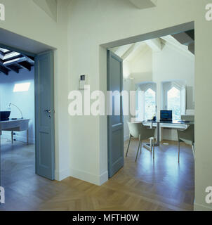 Minimalist home office seen through open doorway Stock Photo