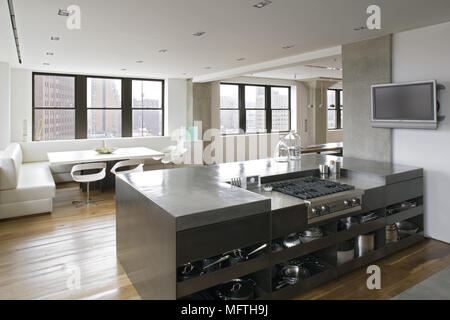 Hob set in unit in modern open plan kitchen with dining area Stock Photo