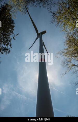 Big windmills for wind power near the village Stock Photo