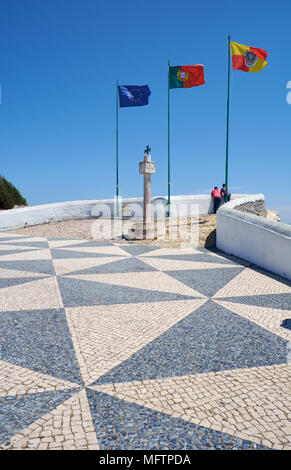Flags of European Union, Portugal and Nazare fluttering over the Miradouro do Suberco view point covered with tradition Portuguese pavement mosaic. Na Stock Photo