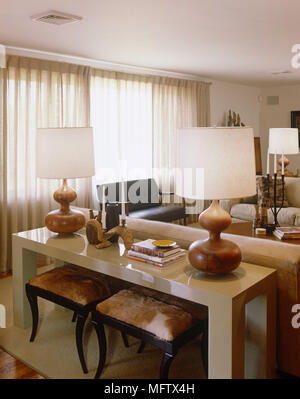 Pair of lamps on side table in modern sitting room Stock Photo