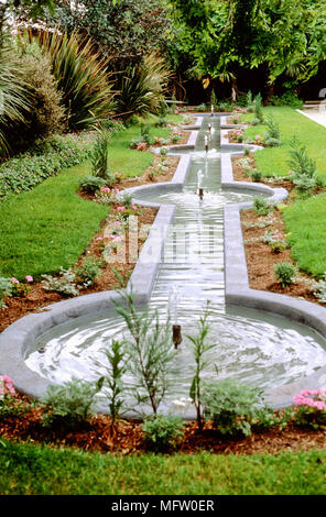 A series of small water fountains in formal garden Stock Photo