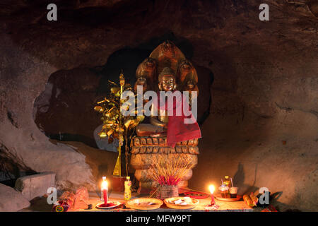 A sitting Buddha effigy in the Kampong caves, Kep, Kampot, Cambodia Stock Photo