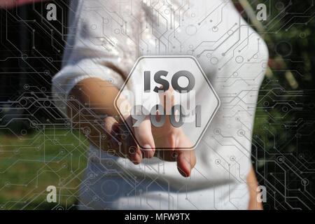 The businesswoman chooses an ISO 9001, presses a button on the touch screen in the global network Stock Photo