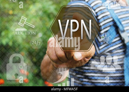 Elderly businessman, the farmer chooses  a VPN on the touch screen. Virtual private network web tag.Сoncept internet technology. Stock Photo