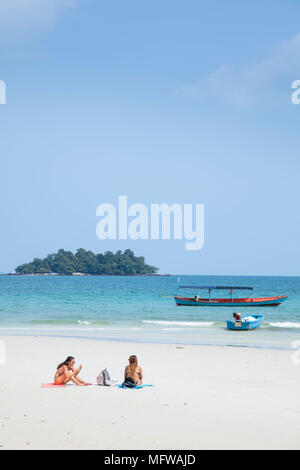 Travellers relaxing on Long Set beach on Koh Rong island in Cambodia Stock Photo