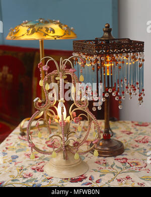 Old fashioned style lamps on table with floral pattern cloth Stock Photo
