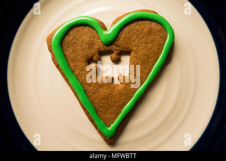 A cinnamon heart with a jigsaw-puzzle piece mising Stock Photo