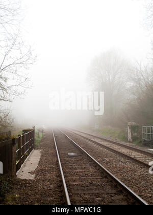 Wessex main line railway tracks at West Dean station serving Southampton to Salisbury via Romsey, taken on early misty spring morning Stock Photo