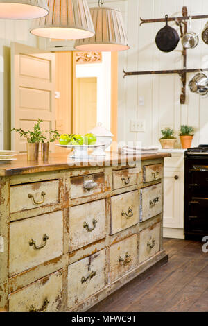 Chest of drawers unit with distressed finish in country style kitchen Stock Photo