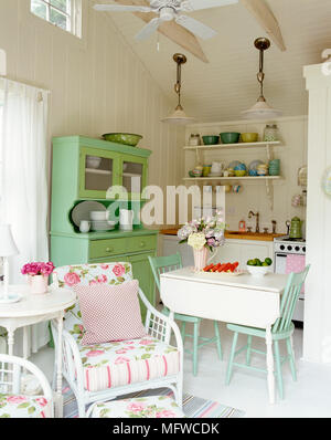 Breakfast table in centre of country style kitchen dining room Stock Photo