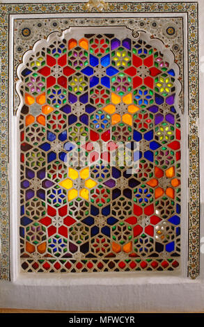 Richly decorated window screen with brightly coloured stained glass Stock Photo