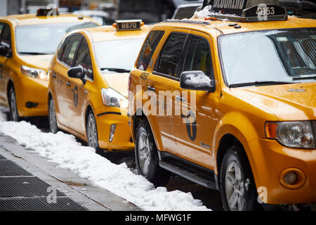 Manhattan in New York City  modern yellow taxis resting in the snow Stock Photo