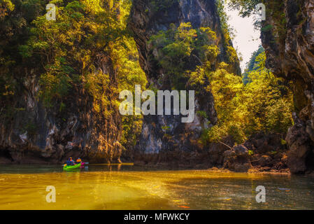 Kayaking under high cliffs in Thailand Stock Photo
