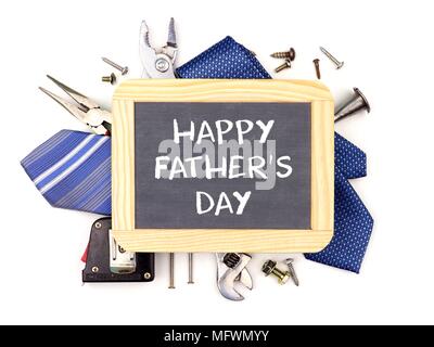 Happy Fathers Day message on a chalkboard with underlying frame of tools and ties isolated on a white background Stock Photo