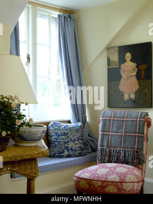Country, sitting room, detail, blue white check curtains, window seat, red floral upholstered chair, cane table, Stock Photo