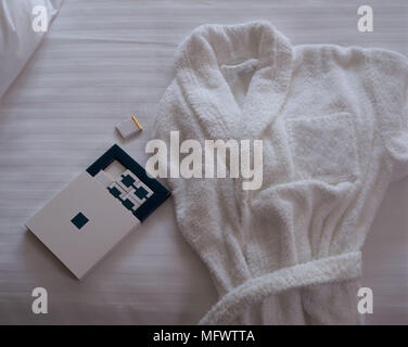 Close-up of a white bathrobe on a bed Stock Photo