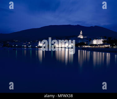 View of an illuminated city along a sea Stock Photo