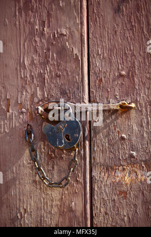 Antique lock and chain on an early American barn door in Colonial Williamsburg Virginia Stock Photo